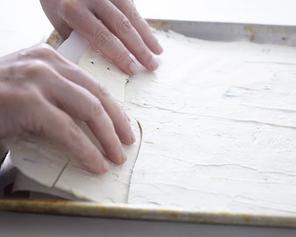 Use both hands to break the sheet into large strips of bark