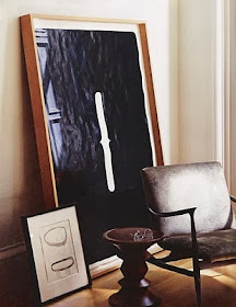 abstract leaning art with chair