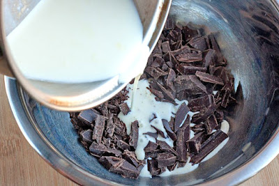 Pour cream over chopped chocolate