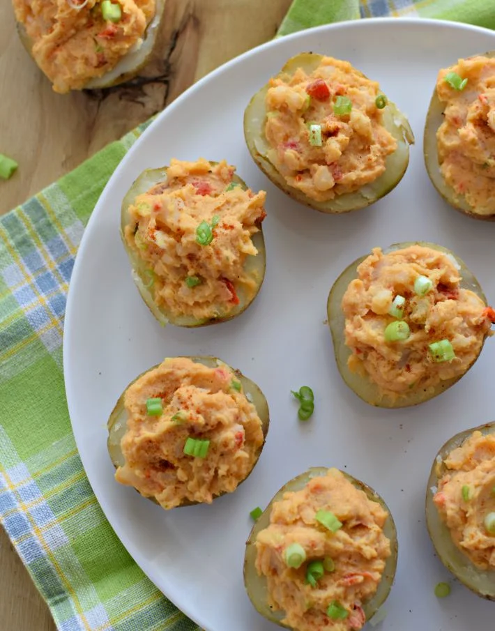 Papas rellenas con hummus de pimientos de piquito asados, decoradas con cebollino picado