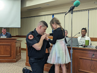 Firefighter Michael Eaton getting pinned by his daughter