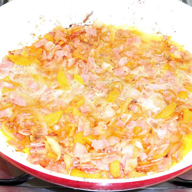 Ingredientes para realizar tomates rellenos de bacon a la cerveza cocinándose en una sartén