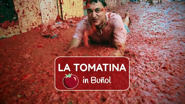 a man in tomatoes at la tomatina festival