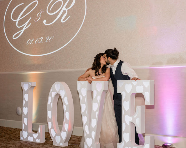 giant love letter with newlyweds