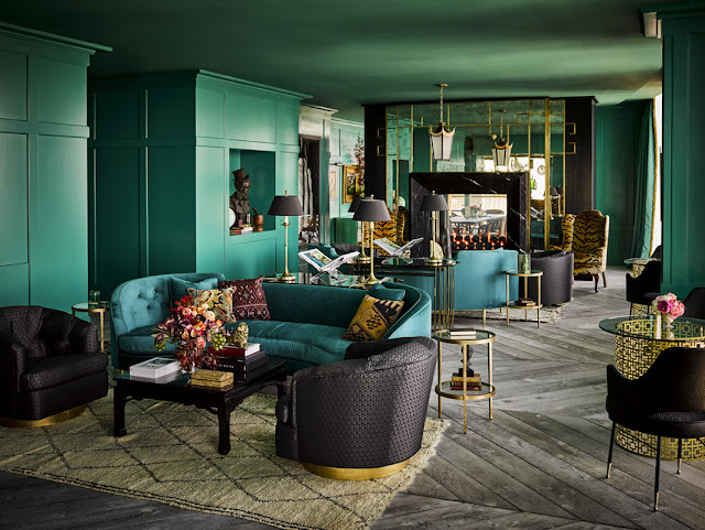 Teal green lacquer painted walls in dramatic lounge by Ken Fulk