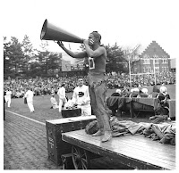 Dartmouth student cheerleader in redface and wearing deerskin leggings at a football game.