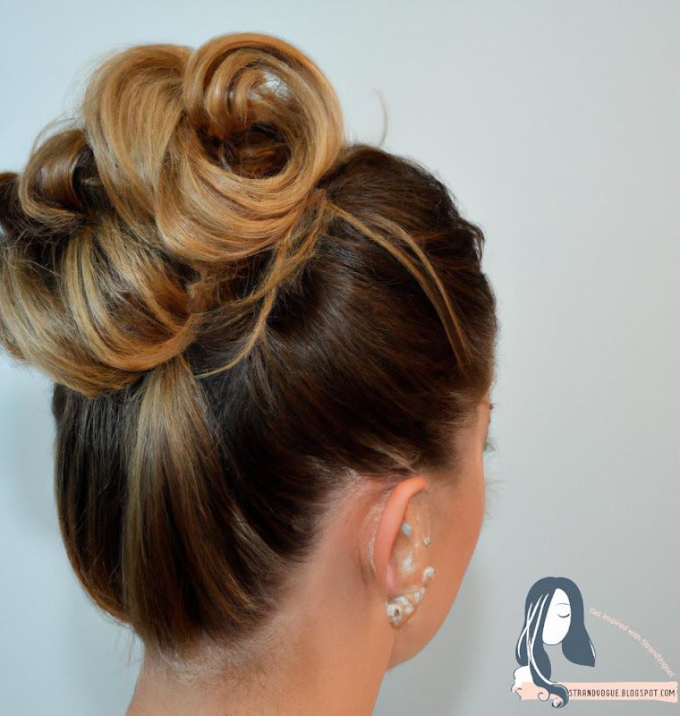 A woman with fine hair in a messy bun.