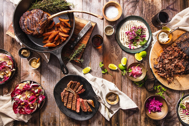 A variety of meals on a wooden table.