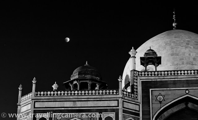 Recently some of my friends had permissions to visit various monuments in Delhi to shoot Lunar Eclipse on 10th Dec, 2011. I also joined them, although all the hard-work for planning these photo-shoots, getting permissions and arranging appropriate equipments was done by other folks. All photographs shared here are not related to the project. These are some of the casual shots taken during eclipse hours on that evening...Here is one of the simple shot when eclipse just started This shot was taken around 6:35 pm on 10th Dec, 2011 !!! Usually Lunar Eclipse used to take place in January, when sky is mainly covered with clouds or fog. Since this time, it happened early, people got to see it clearly and there was huge buzz among various Photography communities.Here is one of the photograph of Humayun's tomb. It's taken with Zoon-in/Zoom-out during long-exposure. Since most of folks were busy on eclipse project and they had to spent 4 hrs at Humayun's tomb, I thought of roaming around and having some clicks of the place in this wonderful lighting, which is rare to capture. Above photograph is also a result of some of the experiments done at Humayun's Tomb, Delhi.Here are some water ponds in all four directions of Humayn's Tomb, but the one in front of entry gate is maintained well. Reflection of the main tomb was looking awesome in Eclipse hours, although above photograph failed to show the real magic... You can see the shining moon in the sky and lovely hues of sunset, when exposed this view for a long time.A similar photograph of Humayn Tomb, with some part of it being reflecting on adjoining water stream... Usually Humayun Tomb closes before Sunset, but if someone wants to have access for some specific purpose, permissions are required in advance.Relatively closer look at Lunar Eclipse through Humayun Tomb. Lunar Eclipse of 10th Dec 2011 can be seen in Photographs at http://www.examiner.com/photography-in-national/yesterday-s-total-lunar-eclipse-photos-1 as well !!!Light and colors were changing with every minute. In fact the change was very prominent for folks who were shooting moon close-ups with tele-photo lenses. After one stage, color of moon starts changing to red and again come back natural shade after few hours...Opposite side of Humayun Tomb, Delhi, INDIAThere are various photography techniques are explained on web and some of them are really technical. At the same time, some of them are really easy to get an idea about the concept and light variation trend during the eclipse hours. In my opinion, understanding the concept and applying your ideas is more important otherwise we always see similar shots on every lunar eclipse. Now many softwares even come with standard ways of capturing lunar eclipse and create single HDR or multi-exposure shots.Carrying Gorilla-pod helps in placing camera at low height, so that some of the other compositions can be tried... No doubt that sturdy and big tripods are important for such shoots but some desi fundas also work well :)Humayun Tomb is very well maintained by Archaeological Survey of India !!! ASI is is the organization to get special permissions to get entry into Humayun Tomb in odd hours. There is lot of green area around main tomb in this campus. And there is very special thing about Mughal Architecture that all four areas around a building are maintained in similar fashion. Alignments of landscapes, gardens and trees would be exactly same.During day time, entry fees for SAARC citizens is 10 Rs. SAARC includes Bangladesh, Nepal, Bhutan, Sri Lanka, Pakistan, Maldives and Afghanistan... BIMSTEC Countries  like Bangladesh, Nepal, Bhutan, Sri Lanka, Thailand and Myanmar also need to pay 10 Rs only. For others it's $5.This photograph would be give you a sense about it's shape and architecture. It has a square base and all four faces of Humayun Tomb look same. Theoretically it's a two storey building but height of one storey is unmatchable :) ... Whole building is made of red stone and Taj Mahal is exactly replica of this building, but in white marble...Light streaks touching ground after filtering through tree leaves around Humayun Tomb... Such photographs from early morning look stunning, as light is most favorable at that point of time of the day...Check following link on wiipedia to know more about Humayun Tomb - http://en.wikipedia.org/wiki/Tomb_of_Humayun . This page has rich information about architecture of Humayun Tomb and history related to it.Humayun Tomb is also in the list of World Heritage sites maintained by UNESCO. Check out http://whc.unesco.org/en/list/232 for more details.Every other site about Delhi has special mention of Humayun Tomb, so I would not repeat all those well known facts about the place. Delhicapital.com has also written about Humayun Tomb in a well structured way... Check it out......A photographer sitting in front of main Tomb in the campus to shoot Lunar Eclipse 2011 with Humayun Tomb in foreground. These folks were sitting at same place, fiddling with camera setting to get best possible multi-exposure shots. Some of them also work on HDRs and hope to see the results soon.Some of the standard techniques of shooting Lunar Eclipses are available here - it was lovely evening with enthusiastic Photographers at Humayun Tomb !!!