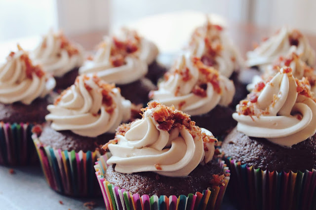 Chocolate sponge cupcakes with a caramel icing. These cupcakes are sprinkled with bits of biscuits