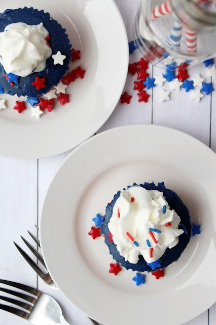 top view of Mini 4th of July Cheesecakes on white plates.