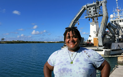 KyAsia Scott-Fishenden standing in front of the RV Atlantic Explorer