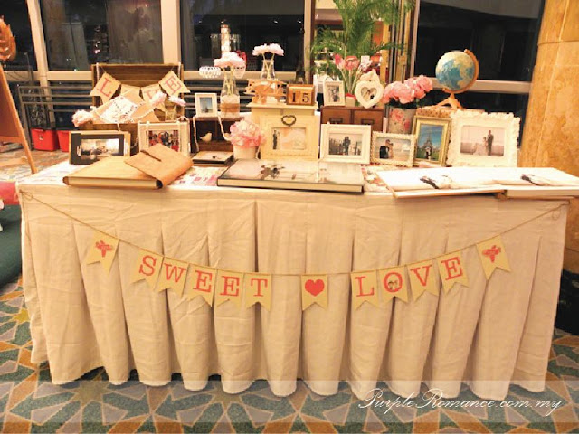 Photo Booth Backdrop Decoration, wooden signage with country names, green carpet, green grass balls, wedding poster, welcome board with country passport stamps, initial, london bags, white fences, aeroplane, cute, clouds, Kuala lumpur, mandarin oriental hotel, selangor