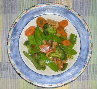 Chinese food with chicken, broccoli, and snow peas