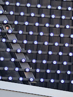 Close up of an array of circular LED fixtures.