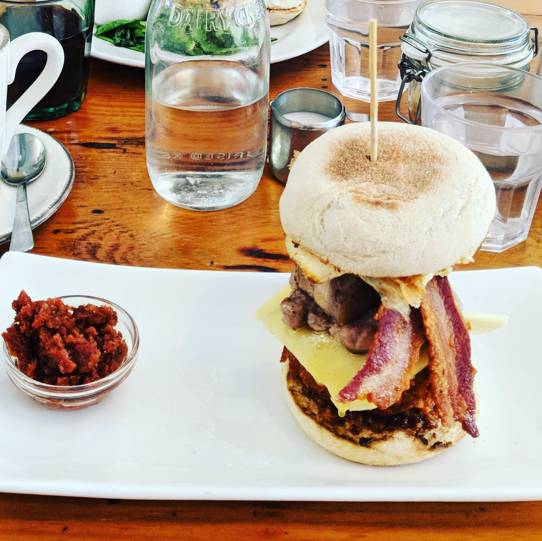 A loaded pork muffin on a table at Hash E8, one of East London's best breakfast spots