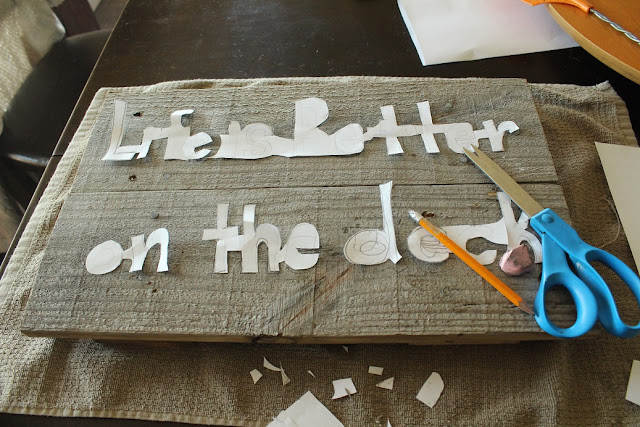 Cutting paper letters out for sign