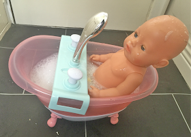 Baby Born doll in Baby Born bath toy 