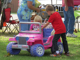 kids driving a battery powered jeep