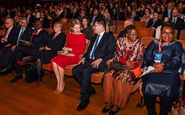 Queen Mathilde wore a red silk midi dress by Natan. Delphine gold earrings