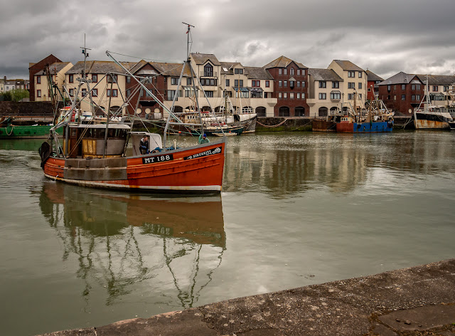 Photo of a fishing boat coming into the harbour to moor up