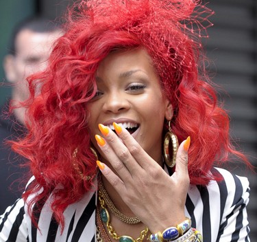 rihanna pictures 2010 red hair. rihanna red hair curly hair.