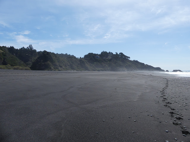 southward to rocks in the waves and houses on the hills