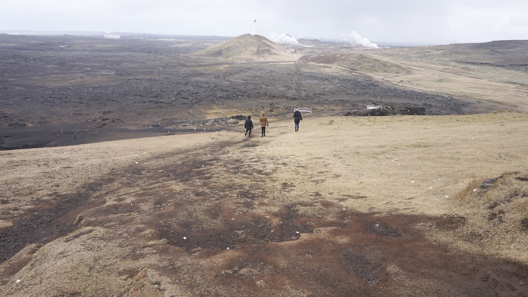 three girls walking down a huge hill in rural Iceland