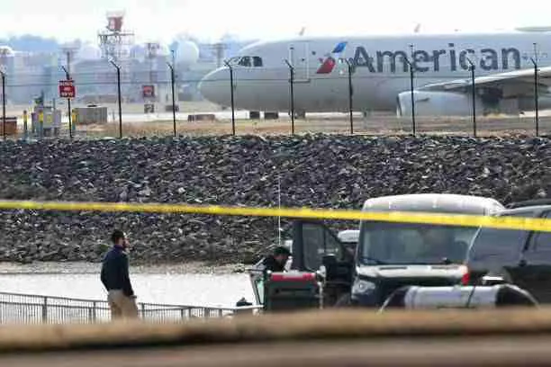 An American Airlines plane prepares to take off as investigators recover pieces of wreckage from the Potomac River after American Airlines Flight 5342 crashed into the water following a collision with a U.S. Army helicopter near Washington, DC, on January 30, 2025. Photo by Andrew Caballero-Reynolds/AFP/Getty Images