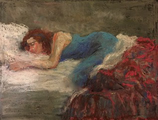 a girl sleeping on her stomach and is covered with red and blue quilt