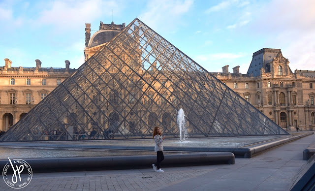 louvre pyramid, woman walking