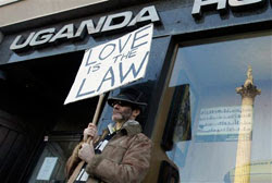 A gay rights demonstrator takes part in a protest outside the Uganda High Commission, as Nelson’s Column is reflected in a window, in London, Thursday, Dec. 10, 2009    (Source:AP Photo/Matt Dunham) 