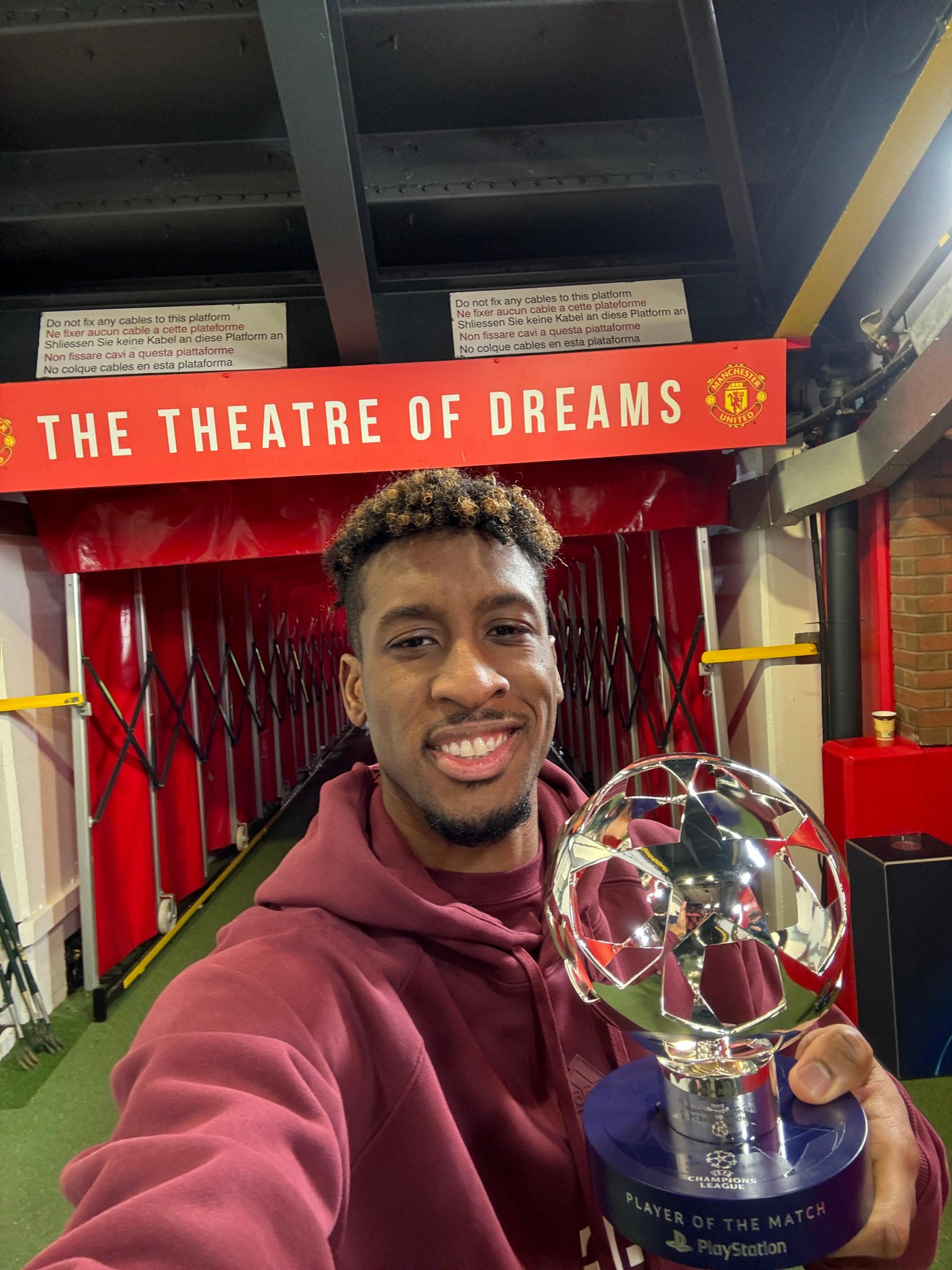 Bayern Munich French winger, Kingsley Coman, pose with his Player Of The Match award following Bayern Munich's Uefa Champions League 2023/24 1-0 win over Manchester United at Old Trafford on Tuesday 12 December, 2023