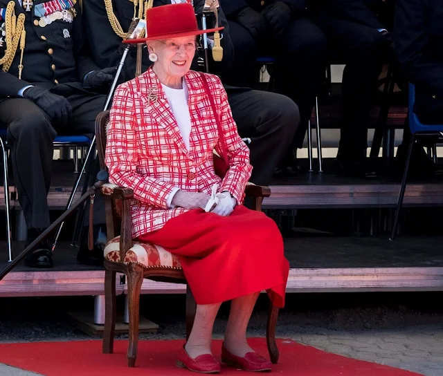 Queen Margrethe wore a red checked jacket, white silk blouse, and a red midi skirt. Suede red flat shoes