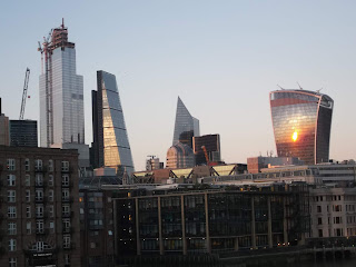 View of London City skyscrapers at sunset from Millennium Bridge