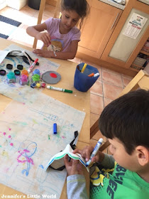 Children painting at the kitchen table