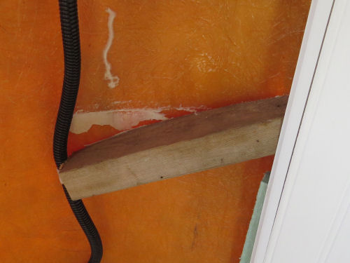 wood brace pulled loose from fiberglass wall