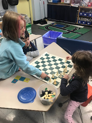 girl setting up chess board