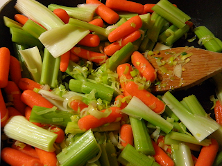Carrots and Celery Being Stirred with Sauteed Leeks