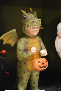 child dressed as a dragon for Halloween, collectible figure from Shelley B Home and Holiday
