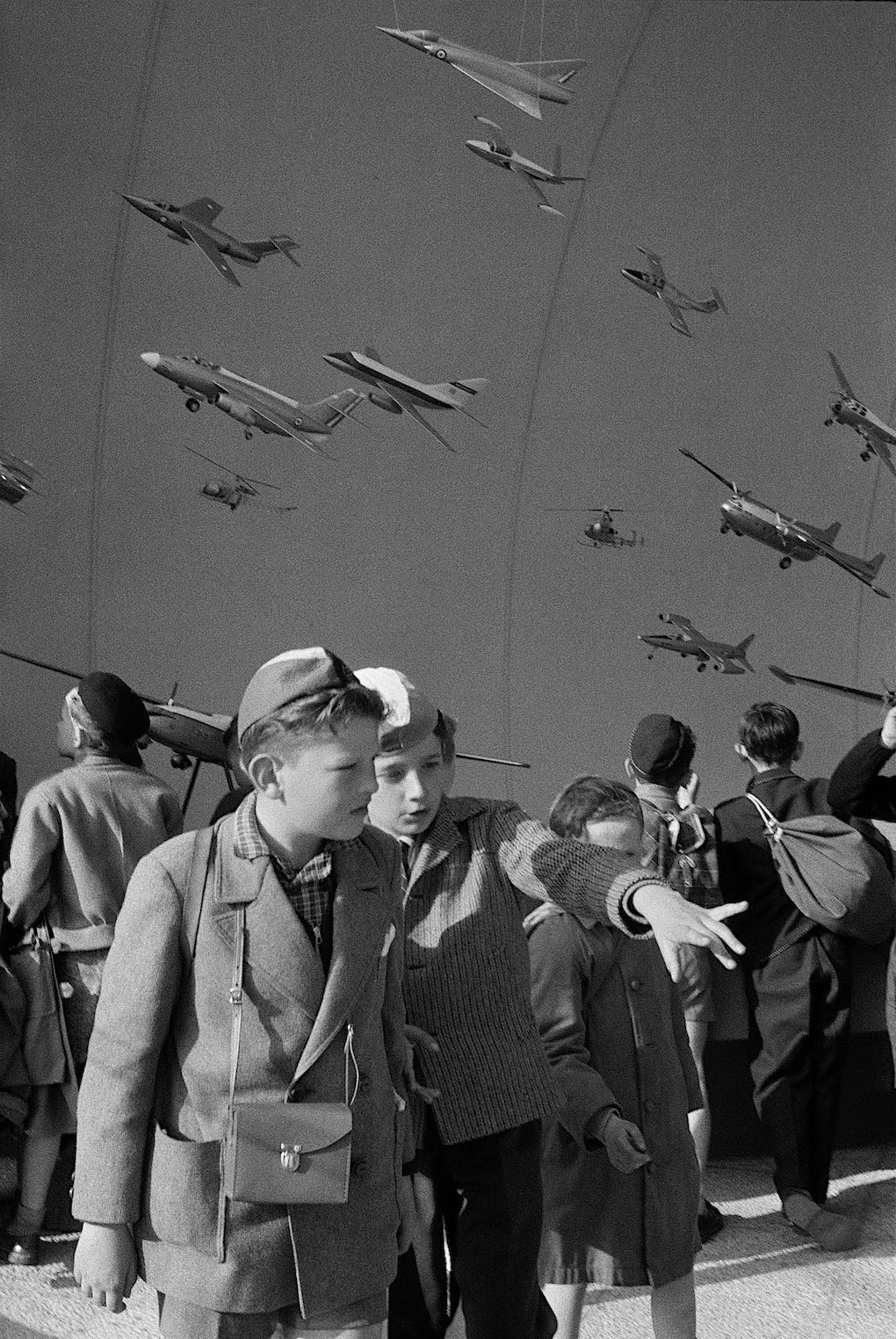 Henri Cartier-Bresson candid photograph of boys and war planes