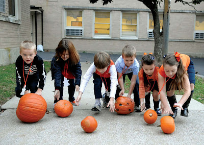 Pumpkin Roll: Determine a starting line and a finish line. Players have to roll their pumpkins over the finish line to win the game.