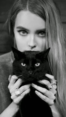 Young woman with a black cat