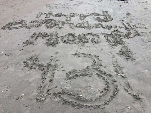 The words 'Happy Birthday Mom 43' are written in the sand.