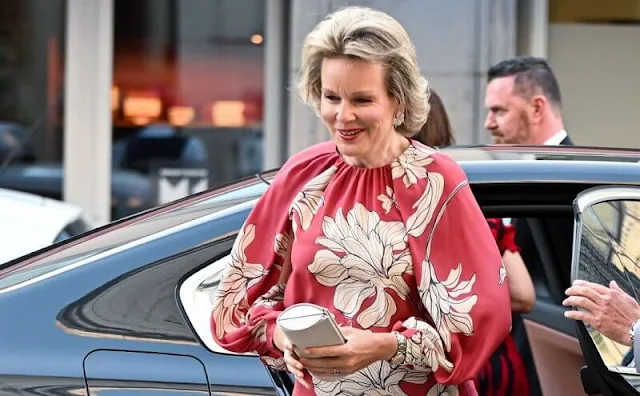 Queen Mathilde wore a new floral print long sleeve gown by Natan Couture. Armani clutch bag and Armani shoes