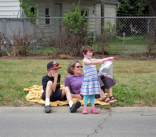 happy girl getting candy at parade, nice, friendly