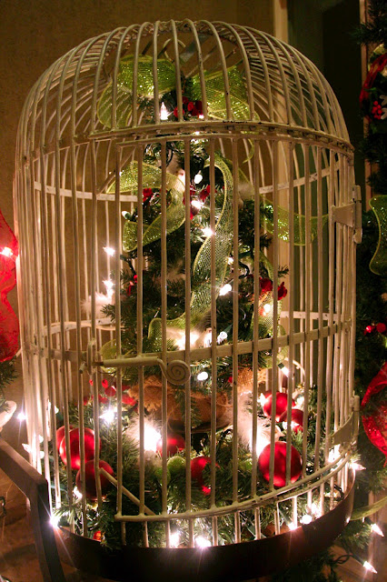 bird cage with Christmas tree and lights and bows