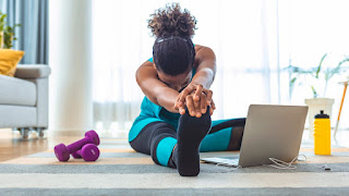 Woman stretching her leg in her lounge