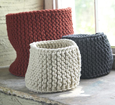 three hand-knitted rope baskets