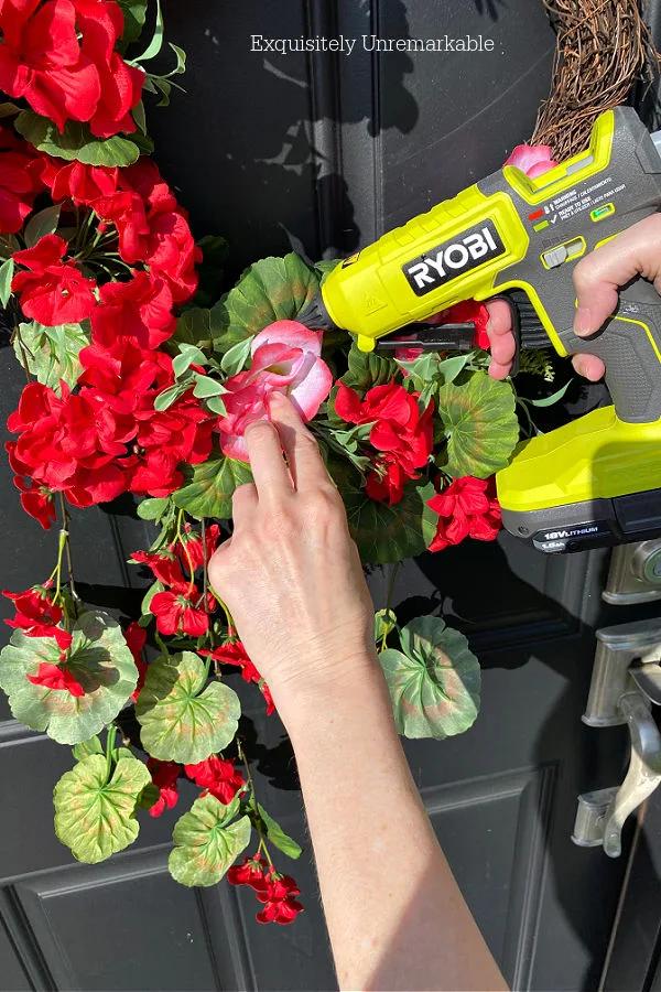 Hot Gluing Faux Flowers To Wreath